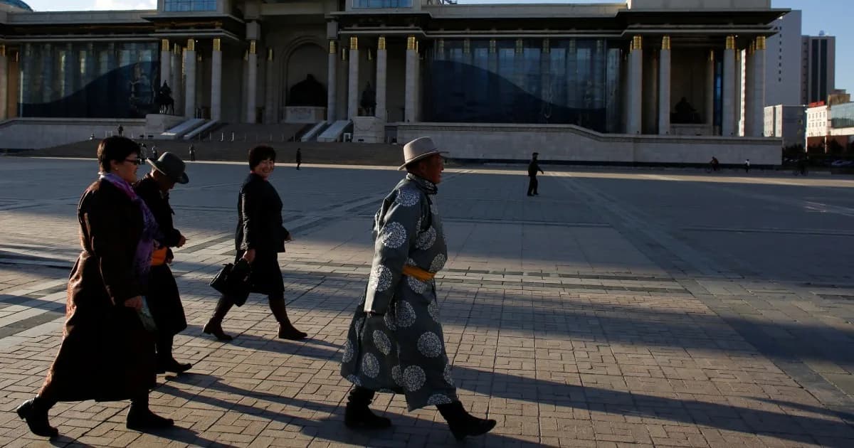 People walk past the State Palace on Sukhbaatar Square in Ulaanbaatar, Reuters
