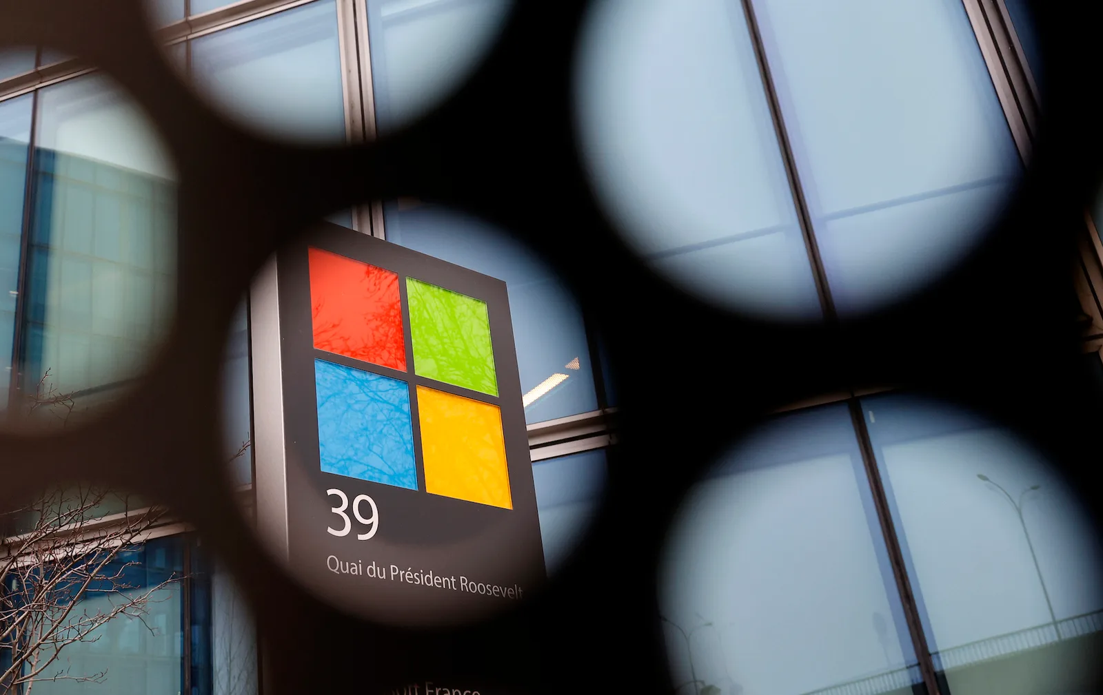 Microsoft logo seen through a grid on the facade of its French headquarters
