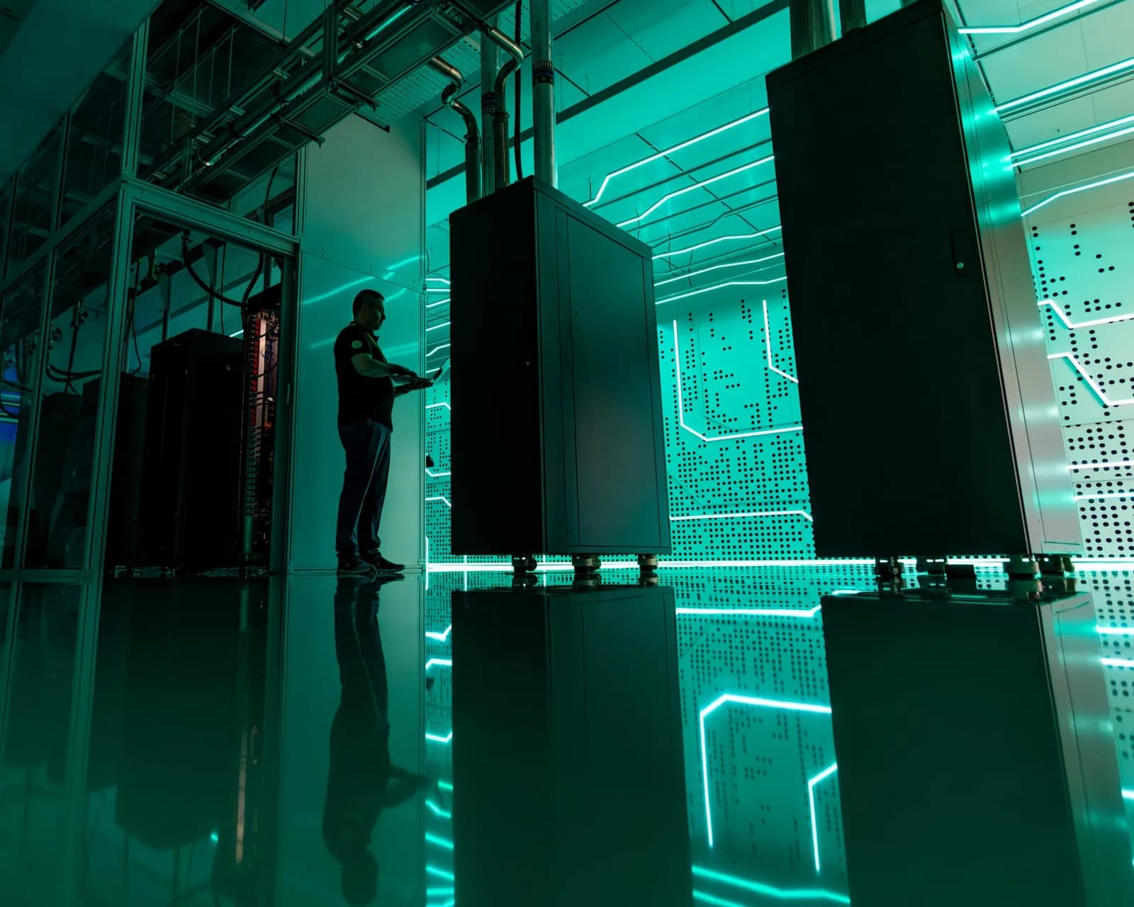 A technician checks liquid-cooled server racks at a datacentre in London